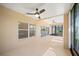 Covered patio featuring neutral toned tile flooring and ceiling fans, with sliding doors to the outdoors at 4254 Berwick Dr, Lake Wales, FL 33859