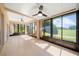 Enclosed sunroom with tile flooring, ceiling fans, and large windows offering bright natural light and outdoor views at 4254 Berwick Dr, Lake Wales, FL 33859