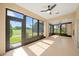 The sunroom features lots of windows and tile floor overlooking a golf course at 4254 Berwick Dr, Lake Wales, FL 33859