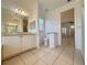 Bathroom featuring tile floors, vanity with ample storage, and seamless flow into adjacent rooms at 4469 Turnberry Ln, Lake Wales, FL 33859