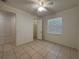 This bright bedroom features tile flooring, a window, and a closet at 4469 Turnberry Ln, Lake Wales, FL 33859