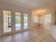 Bright dining area with tile floors, glass doors to a patio, and an elegant chandelier at 4469 Turnberry Ln, Lake Wales, FL 33859