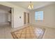 Dining room features tile floors with decorative inlay and a stylish chandelier at 4469 Turnberry Ln, Lake Wales, FL 33859