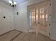 Hallway showcasing classic architectural details, with an open view to other rooms through glass doors at 4469 Turnberry Ln, Lake Wales, FL 33859