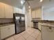 Well-appointed kitchen with stainless steel appliances, ample cabinet space, and tiled floors at 4469 Turnberry Ln, Lake Wales, FL 33859