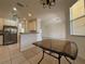 Spacious kitchen featuring stainless steel appliances and a breakfast bar, seamlessly connected to the living area at 4469 Turnberry Ln, Lake Wales, FL 33859