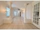 Bright living room featuring elegant columns, tile flooring, and plenty of natural light from large windows at 4469 Turnberry Ln, Lake Wales, FL 33859