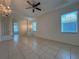 Open-concept living space with tile floors, stylish chandelier, and expansive windows offering ample natural light at 4469 Turnberry Ln, Lake Wales, FL 33859