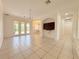 Bright living room features tile floors, high ceilings, and elegant chandelier at 4469 Turnberry Ln, Lake Wales, FL 33859