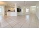 Spacious living room showcasing tile flooring, a kitchen bar and modern design at 4469 Turnberry Ln, Lake Wales, FL 33859