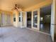 Open patio with ceiling fan and multiple access points to the interior, showcasing a seamless indoor-outdoor flow at 4469 Turnberry Ln, Lake Wales, FL 33859