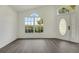 Bright entryway with wood floors, natural light from a large window, and a decorative front door at 529 Terranova Cir, Winter Haven, FL 33884