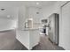 Bright and modern kitchen with white cabinets, stainless steel appliances, and a large island with breakfast bar at 529 Terranova Cir, Winter Haven, FL 33884