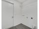 Bright laundry room with white walls and gray wood floors, providing a clean and functional space at 529 Terranova Cir, Winter Haven, FL 33884