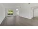 Open-concept living room with vaulted ceiling, wood floors, lots of natural light, and freshly painted walls at 529 Terranova Cir, Winter Haven, FL 33884
