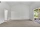 Spacious bedroom with carpet, neutral walls, and a sliding glass door leading to a screened patio at 529 Terranova Cir, Winter Haven, FL 33884