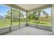 Screened-in patio offers views of the lush, green backyard and tropical landscaping at 529 Terranova Cir, Winter Haven, FL 33884