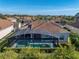Aerial view of a home featuring a screened in pool enclosure at 5340 Nicklaus Dr, Winter Haven, FL 33884