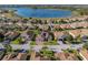 Aerial view of a residential community showcasing a single-Gathering home with solar panels and lake views at 5340 Nicklaus Dr, Winter Haven, FL 33884