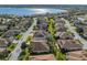 Aerial view showing a residential community and a single-Gathering home with solar panels near a lake at 5340 Nicklaus Dr, Winter Haven, FL 33884