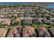 Aerial shot of a residential community with a single-Gathering home featuring solar panels at 5340 Nicklaus Dr, Winter Haven, FL 33884