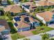 Aerial shot of a single-Gathering home with solar panels, a screened pool, and a brick driveway at 5340 Nicklaus Dr, Winter Haven, FL 33884