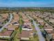 Aerial view of a residential community, highlighting a house with solar panels at 5340 Nicklaus Dr, Winter Haven, FL 33884