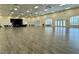 Spacious community auditorium featuring a stage, wood flooring, large windows with shutters and ceiling fans at 5340 Nicklaus Dr, Winter Haven, FL 33884