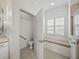 Elegant bathroom featuring a toilet room, window seat, and neutral tile at 5340 Nicklaus Dr, Winter Haven, FL 33884