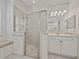 Bathroom featuring tiled walk-in shower, vanity with lighting, and a window bench at 5340 Nicklaus Dr, Winter Haven, FL 33884