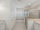 Well-lit bathroom with a glass-enclosed shower, window seat, and spacious vanity at 5340 Nicklaus Dr, Winter Haven, FL 33884
