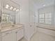 Beautiful bathroom with a large vanity, shower, and a window seat with shutters at 5340 Nicklaus Dr, Winter Haven, FL 33884