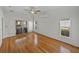 Comfortable bedroom with sliding glass door leading to a screened lanai, ceiling fan, and hardwood floors at 5340 Nicklaus Dr, Winter Haven, FL 33884