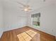 Bedroom features hardwood floors, ceiling fan, and window letting in natural light at 5340 Nicklaus Dr, Winter Haven, FL 33884
