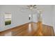 Bright bedroom with two windows and a ceiling fan, featuring hardwood flooring at 5340 Nicklaus Dr, Winter Haven, FL 33884