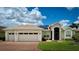 Charming single-story home boasts a three-car garage, lush lawn, and well-maintained landscaping at 5340 Nicklaus Dr, Winter Haven, FL 33884