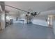 Spacious garage with epoxy flooring, storage units, and bright lighting at 5340 Nicklaus Dr, Winter Haven, FL 33884