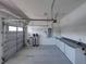View of the garage including the automatic door, water filtration system, and built-in cabinetry at 5340 Nicklaus Dr, Winter Haven, FL 33884