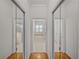 Hallway featuring mirrored closets and an entrance to the bathroom at 5340 Nicklaus Dr, Winter Haven, FL 33884