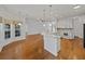 Spacious kitchen with open floor plan, wooden floors, and stainless steel appliances at 5340 Nicklaus Dr, Winter Haven, FL 33884