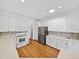 Well-equipped kitchen with stainless steel appliances, ample counter space, and white cabinetry at 5340 Nicklaus Dr, Winter Haven, FL 33884