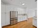 Kitchen with stainless steel refrigerator, granite countertops, and white cabinetry at 5340 Nicklaus Dr, Winter Haven, FL 33884