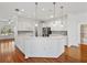 Modern kitchen featuring white cabinets, stainless steel appliances, and hardwood floors at 5340 Nicklaus Dr, Winter Haven, FL 33884