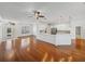 Open concept living space with hardwood floors, connecting to a modern kitchen with white cabinets at 5340 Nicklaus Dr, Winter Haven, FL 33884