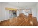 Open living room with wooden floors, neutral walls, and views into the kitchen at 5340 Nicklaus Dr, Winter Haven, FL 33884