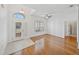 Bright living room featuring hardwood floors, a ceiling fan, and a sunlit entryway at 5340 Nicklaus Dr, Winter Haven, FL 33884