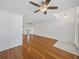 Spacious living area with hardwood floors, ceiling fans, and a view into adjacent rooms at 5340 Nicklaus Dr, Winter Haven, FL 33884