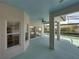 View of the covered patio that leads to a screened-in pool, landscaped backyard, and interior access at 5340 Nicklaus Dr, Winter Haven, FL 33884