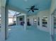 View of the covered patio featuring a ceiling fan, hot tub, and access to a screened pool area at 5340 Nicklaus Dr, Winter Haven, FL 33884