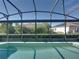 A screened-in pool with a clear view of the neighborhood and landscaping at 5340 Nicklaus Dr, Winter Haven, FL 33884